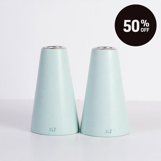 Two mint green taper candle holders with a silver-toned top, shown on a white background with a black 'Up to 50% OFF' promotional badge in the top right corner.