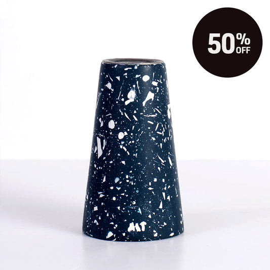 A navy blue terrazzo tapered candle with white speckles, shown on a white background with a black circular '50% OFF' sale badge in the top right corner.