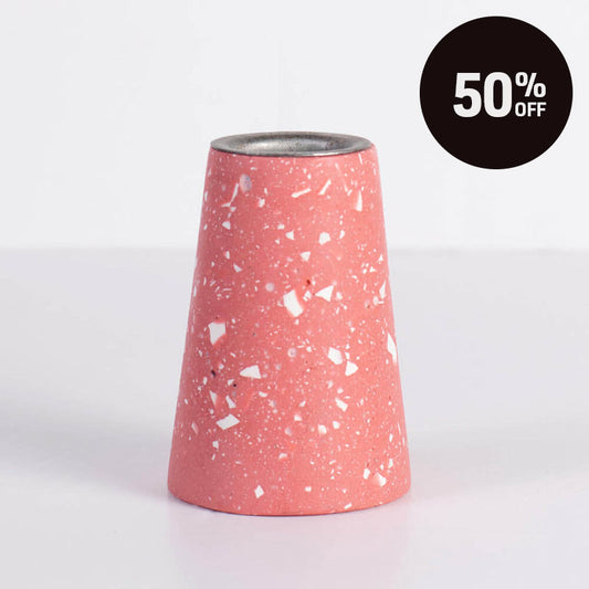 A terrazzo taper candle holder in a dusty pink colour with white terrazzo. A black circular '50% OFF' promotional badge is in the top right corner.