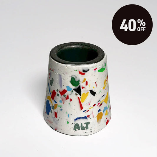 A small tapered taper candle holder with a terrazzo-style multicolour pattern on a white base, shown on a light grey background with a black '40% OFF' promotional badge in the top right corner.