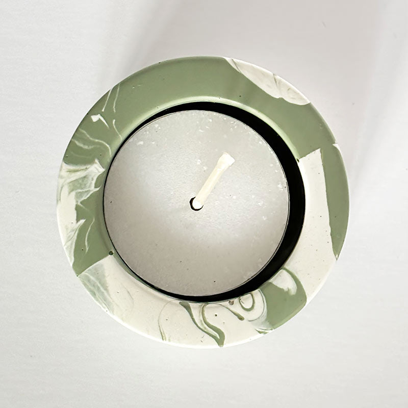 Moss Green Marble Jesmonite Tea Light Holder with a candle 
on a white background