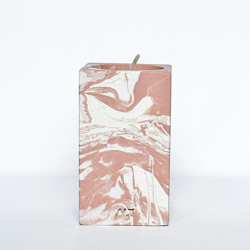 Marble-patterned salmon pink tea light candle holder with 'ALT' branding on a white background