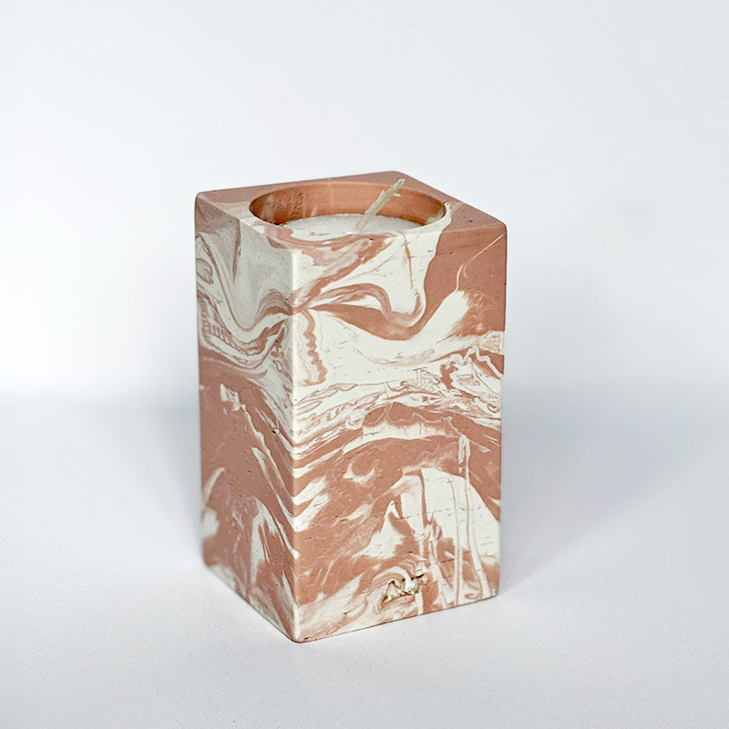 Marble-patterned salmon pink tea light candle holder with 'ALT' branding on a white background
