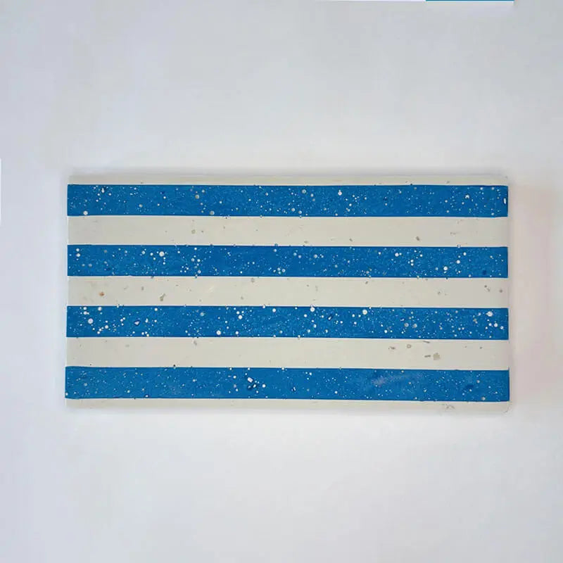 A rectangular tray tile with alternating horizontal stripes of blue and off-white, displayed against a plain white background.