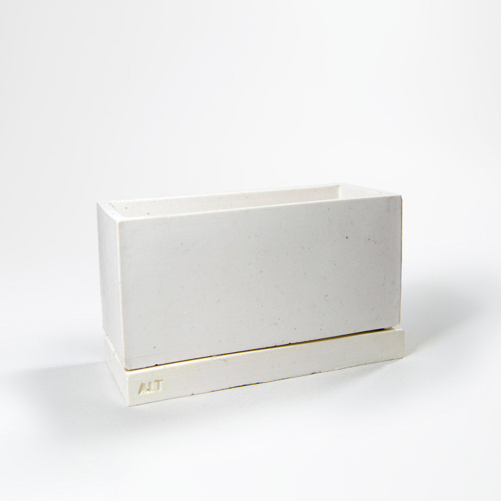 Minimalistic scandi / japandi rectangular grey planter with drainage holes and a water tray box with 'ALT' branding on a white background