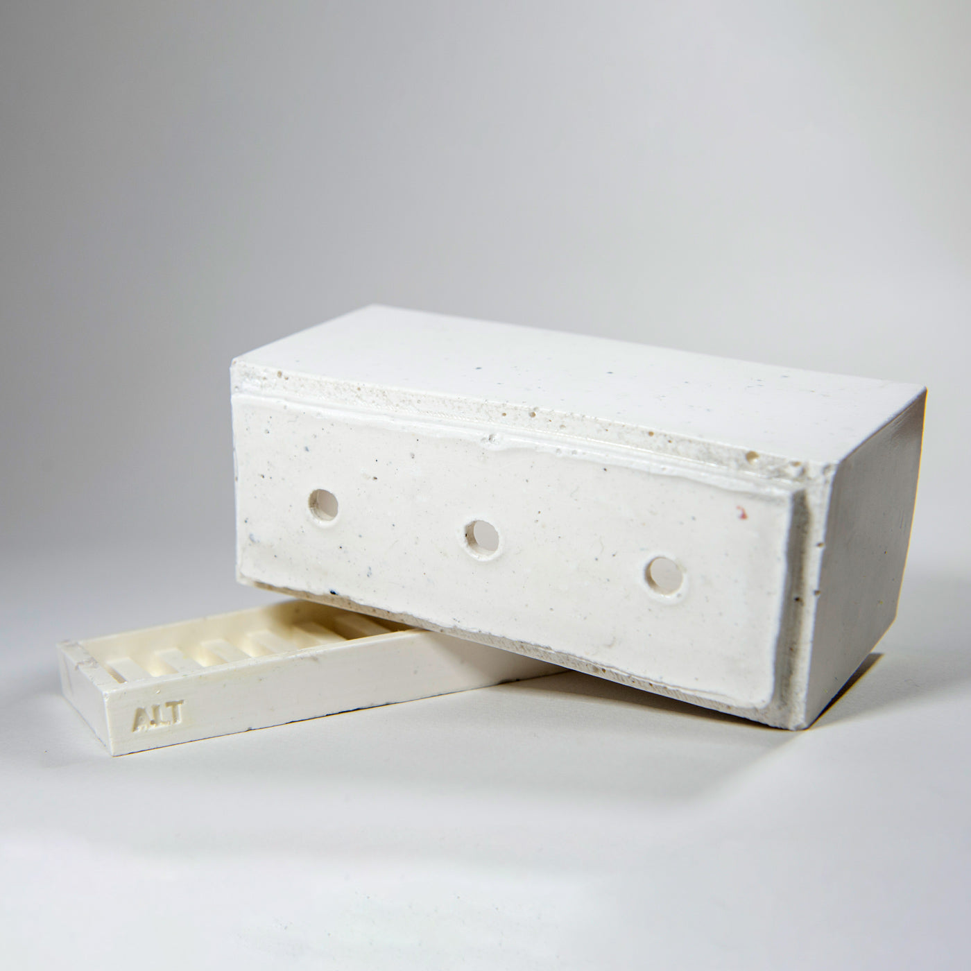 Rectangular grey planter with drainage holes and a water tray box with 'ALT' branding on a white background