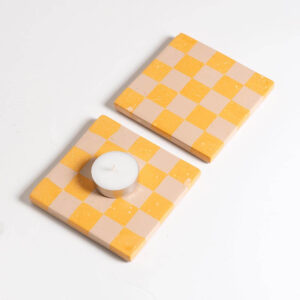 Set of two handcrafted orange and pale pink checkered coasters with a tea light candle and Jesmonite trinket tray